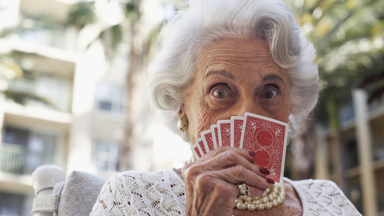 Older woman playing cards