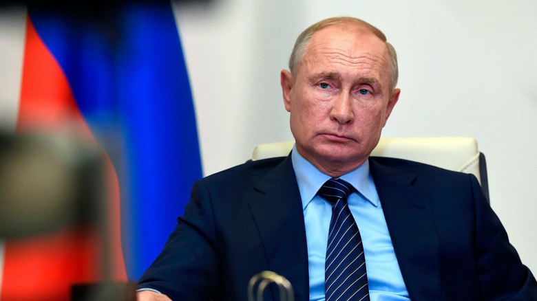 Vladimir Putin sitting at a desk