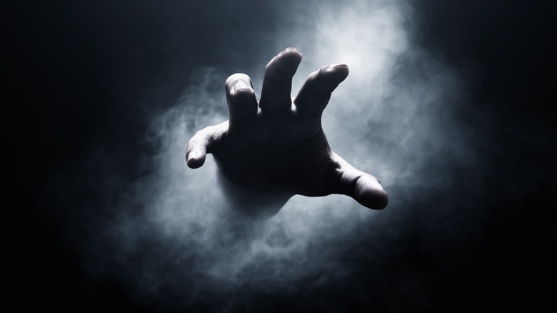 Hand reaching from mist