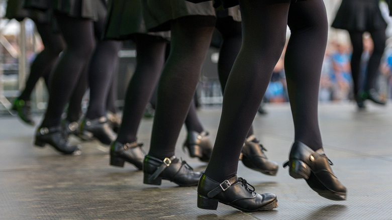 The legs of a line of Irish dancers