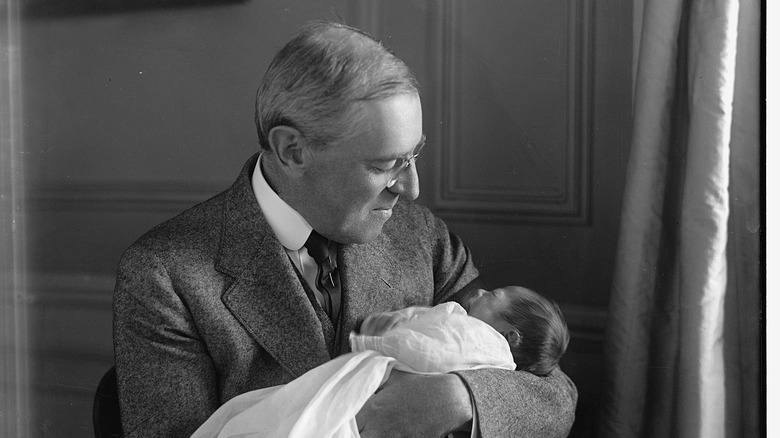 President Woodrow Wilson holding his infant grandson