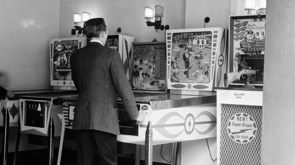 London man playing pinball in 1960s