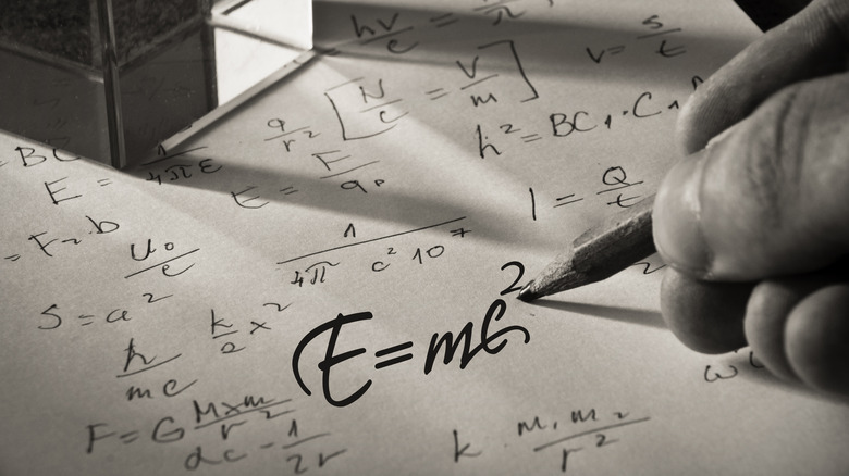 hand writing Einstein's theory of relativity 