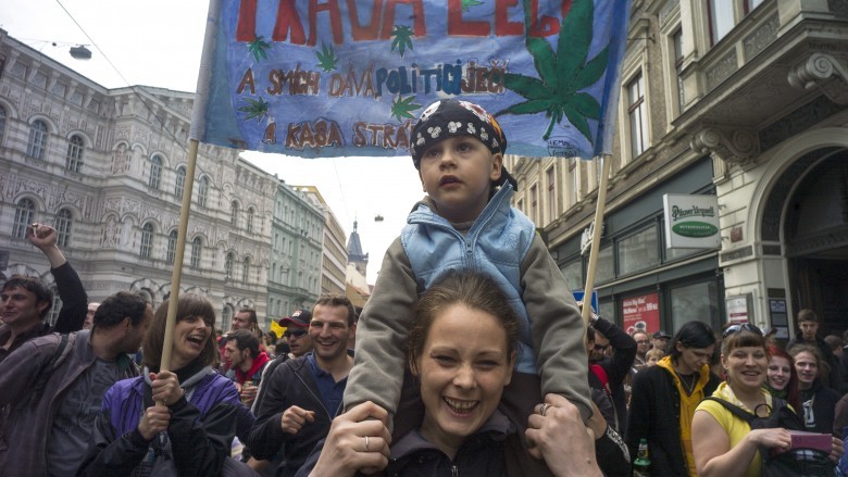 Woman with child on shoulders at street protest