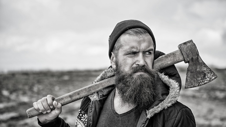 Stern bearded man with an axe