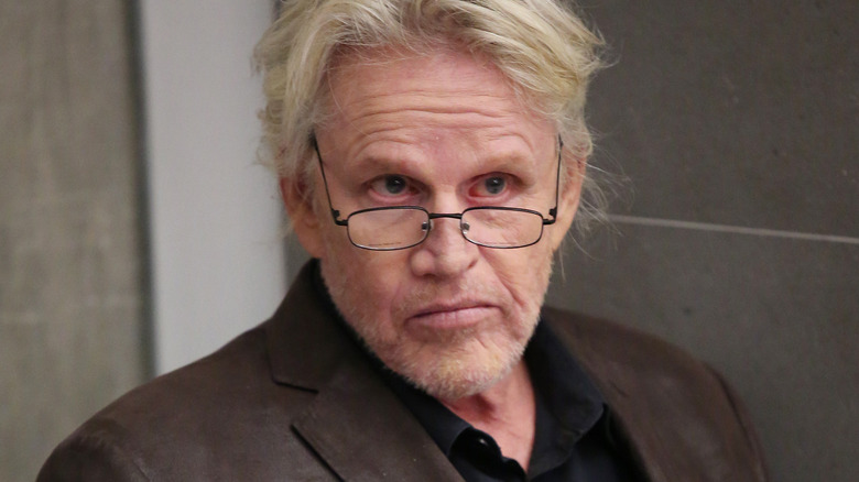 Gary Busey with eyeglasses, posing for a 2022 photo