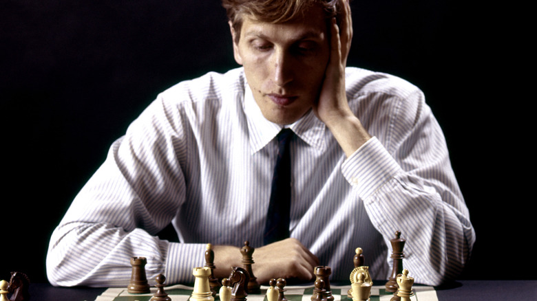 Bobby Fischer studying chess board  