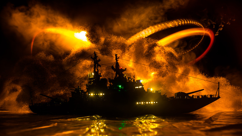 ship silhouette outlined by explosion
