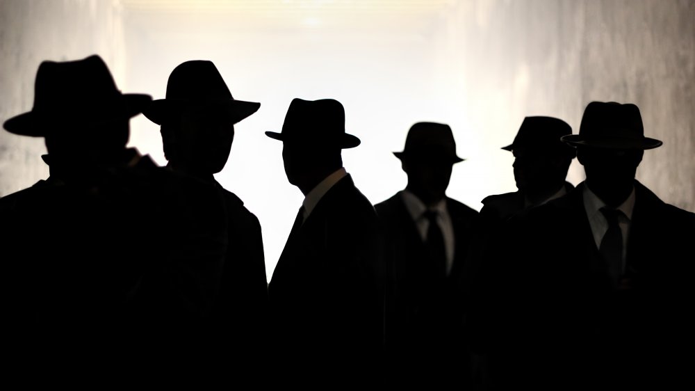 Silhouettes of men in hats