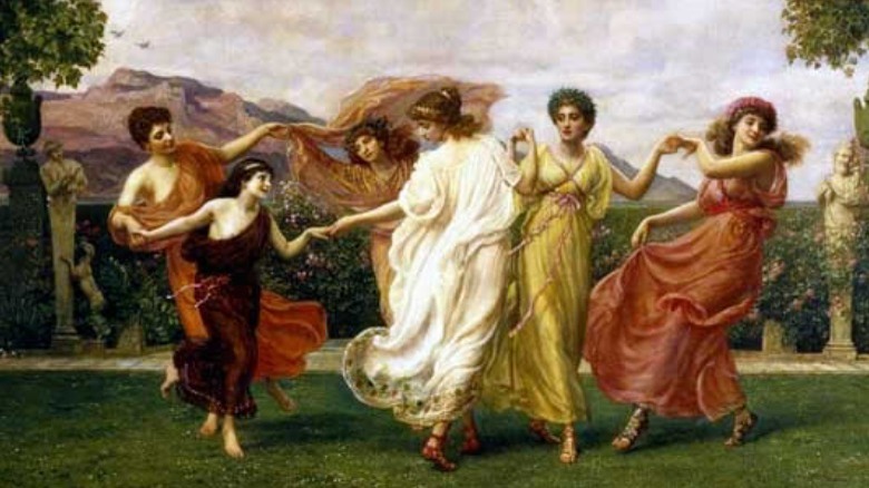 Women colorful dresses garden dancing