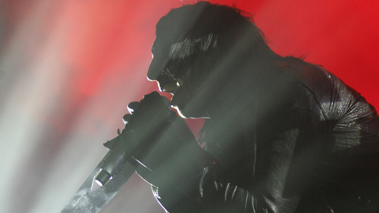 Marilyn Manson silhouetted by light red