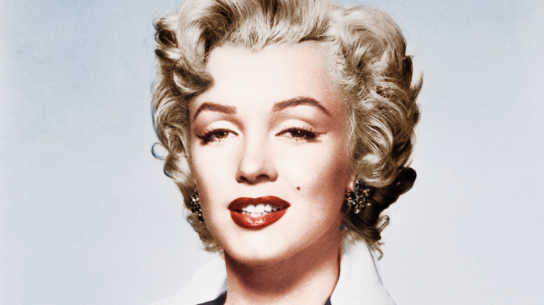 Marilyn Monroe in makeup smiling white background