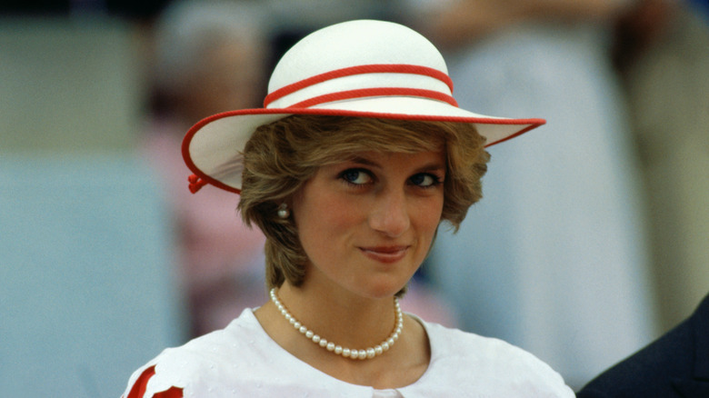 Princess Diana white red hat smiling outside