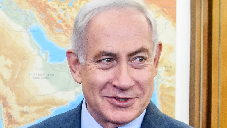 Benjamin Netanyahu standing in front of map