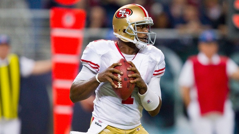 Troy Smith holding football 49ers
