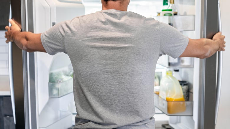 Guy opening refrigerator