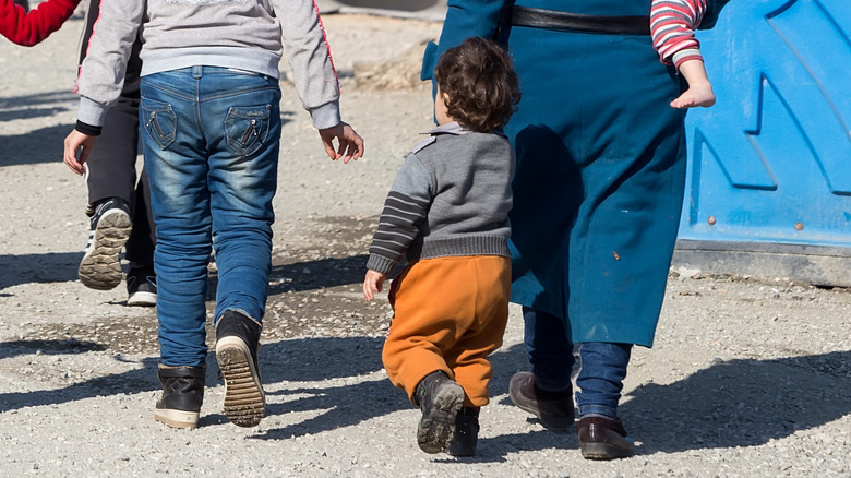 Migrant family fleeing war zone