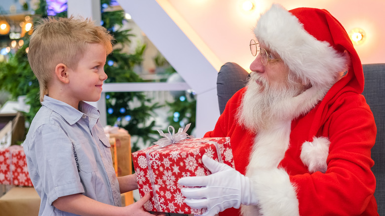 Santa giving a boy a gift