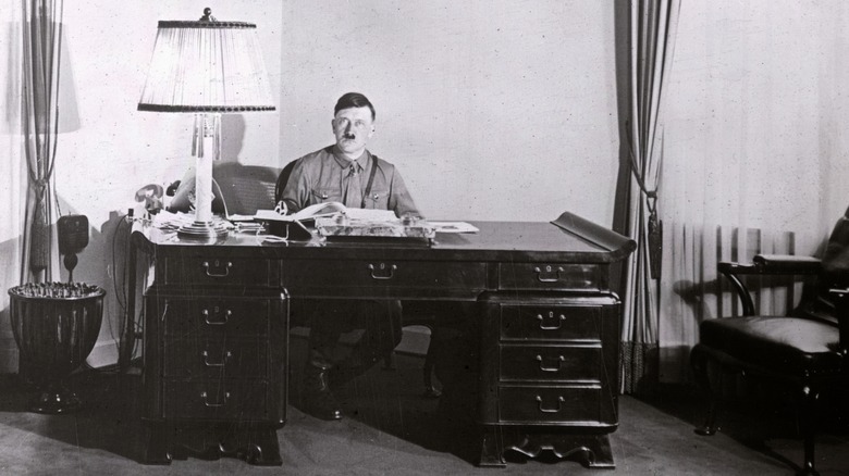 Adolf Hitler sitting at his desk