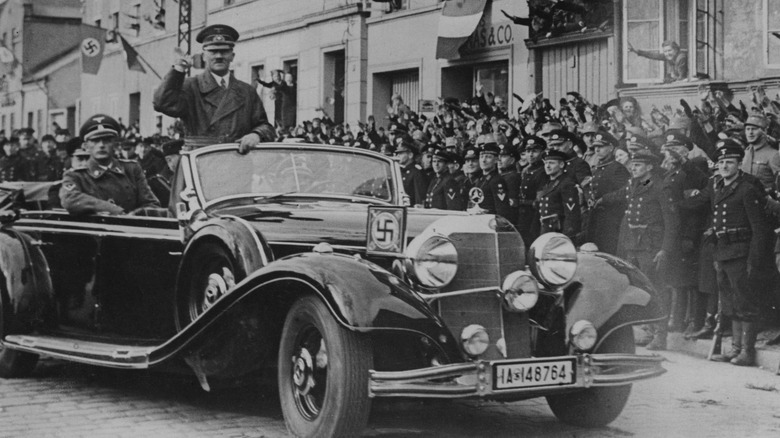 Hitler salutes from car