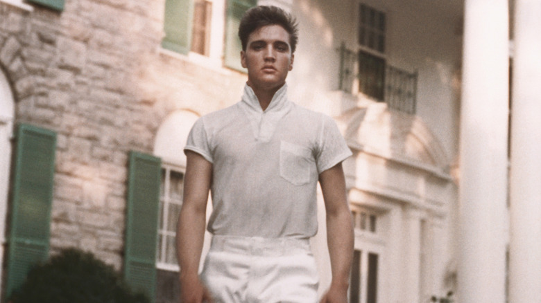 Elvis Presley walking in Graceland grounds