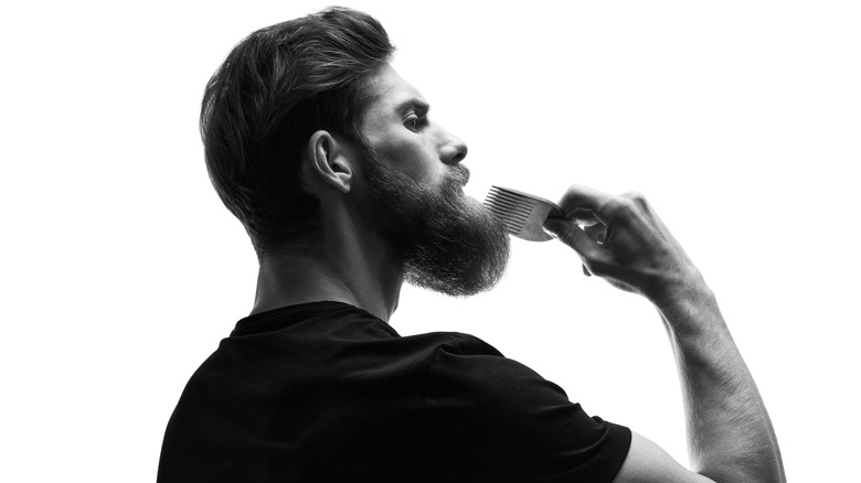 guy combing beard side shot