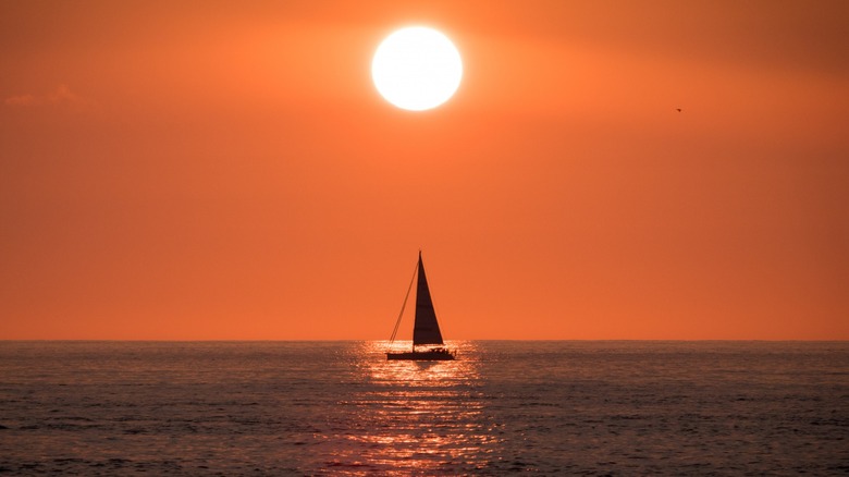 Sailboat at sea at sunset