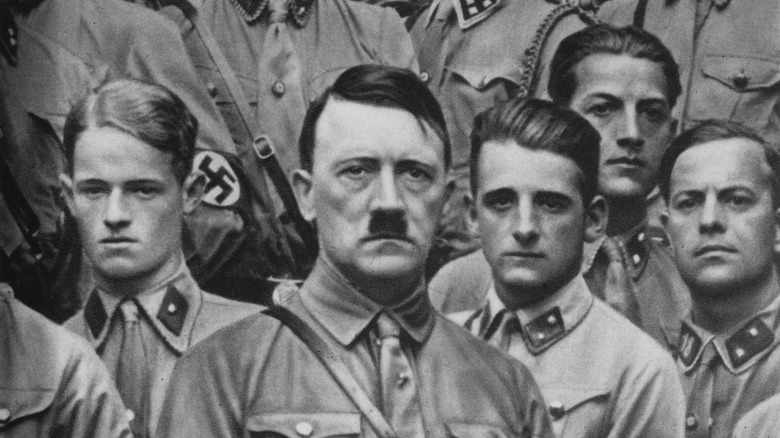 Hitler flanked by Nazi soldiers