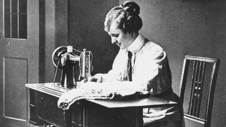 Photo of woman using Singer sewing machine