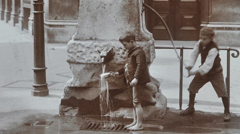 Boy pumps water in London