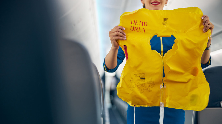 flight attendant with life jacket