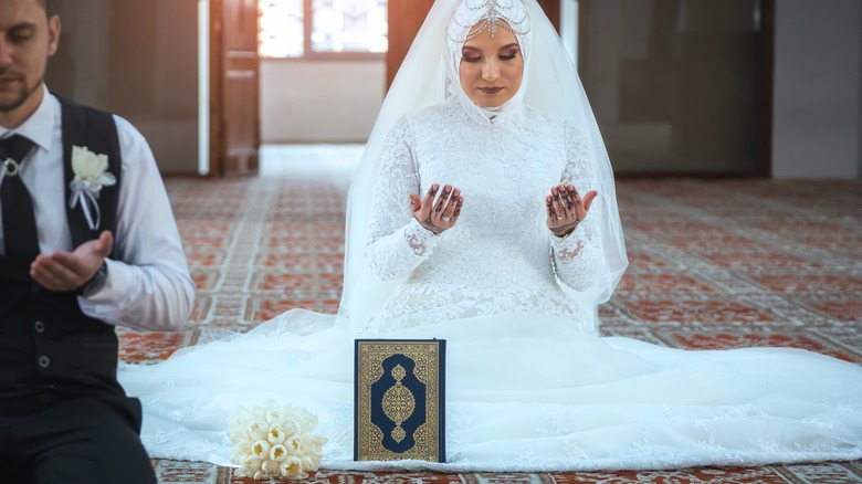 muslim bride praying on ground