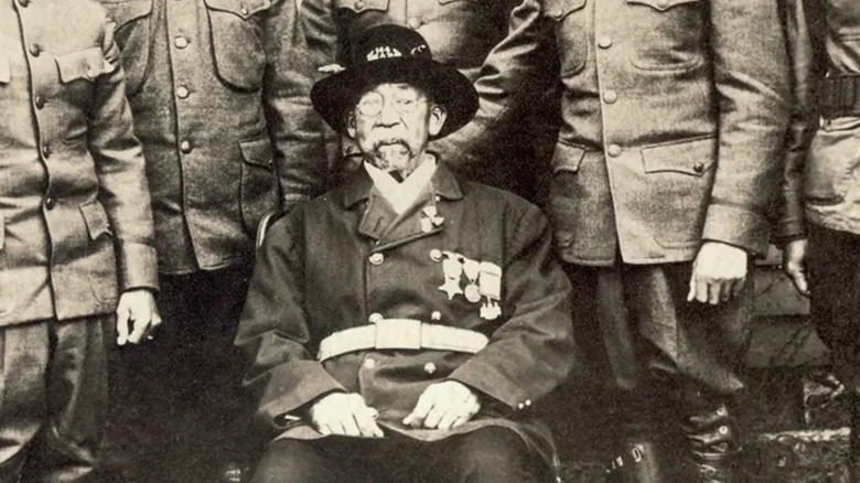 William Gould sitting in uniform with six uniformed sons