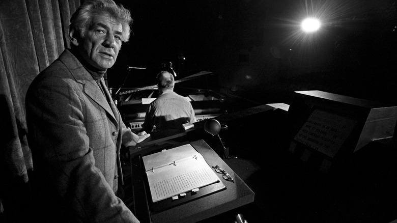 Leonard Bernstein standing at a podium