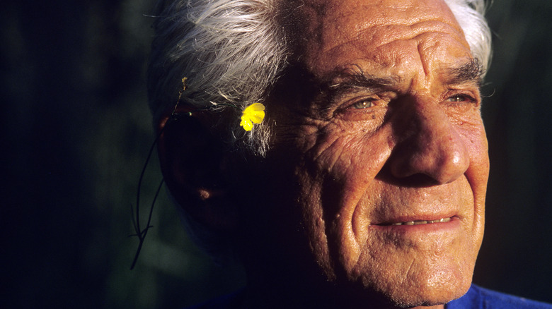 Leonard Bernstein posing for a portrait outside