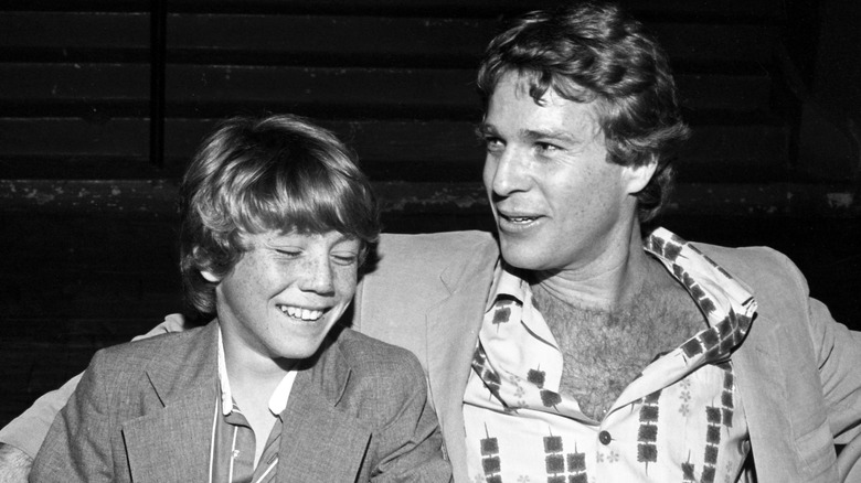 Ryan O'Neal and young Griffin O'Neal sat smiling