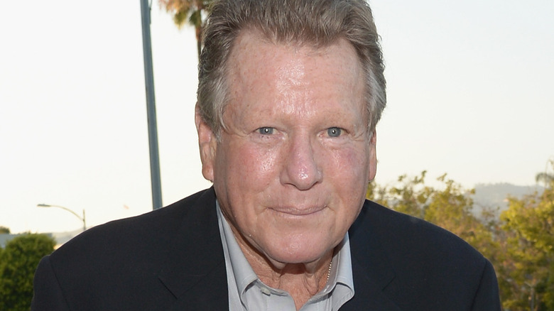 Ryan O'Neal suit smiling outside