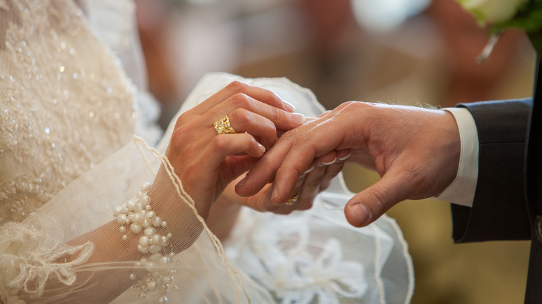 Hands exchanging wedding rings
