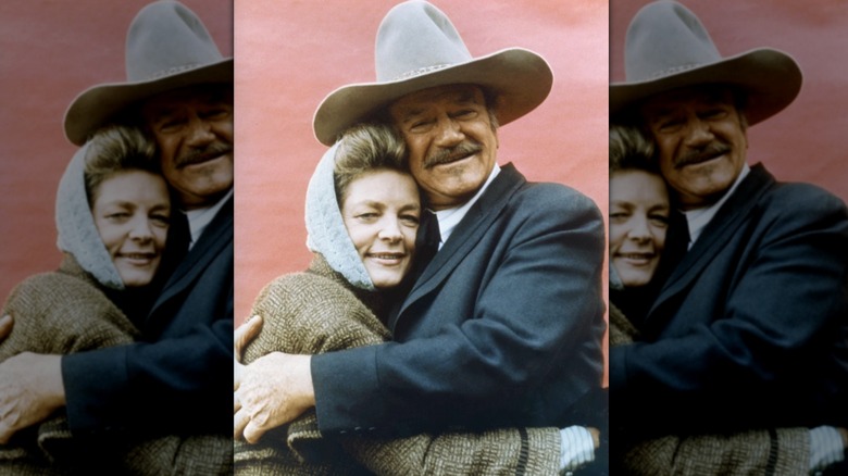 John Wayne embraces Lauren Bacall