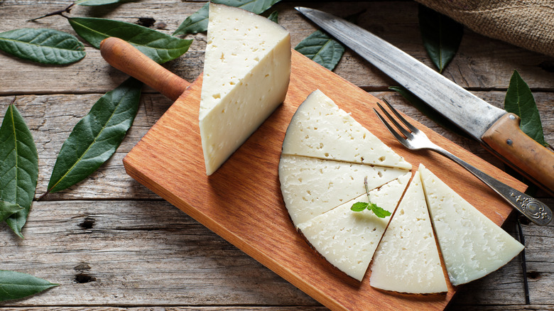 Manchego cheese on cutting board