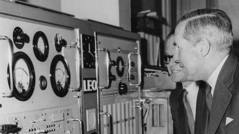 two men examining a computer 1950s