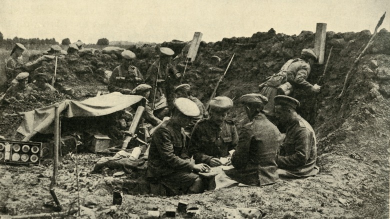 soldiers playing cards in trench