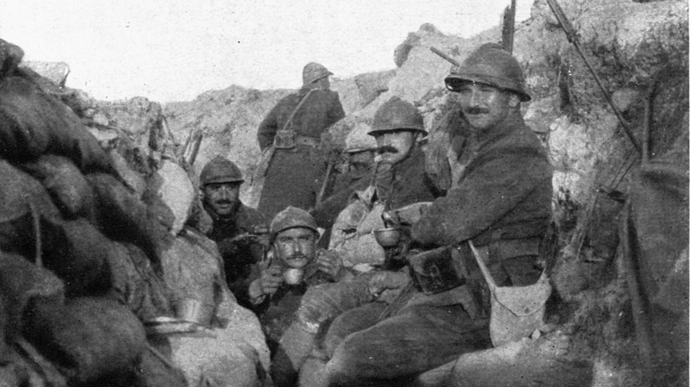 soldiers eating in trench