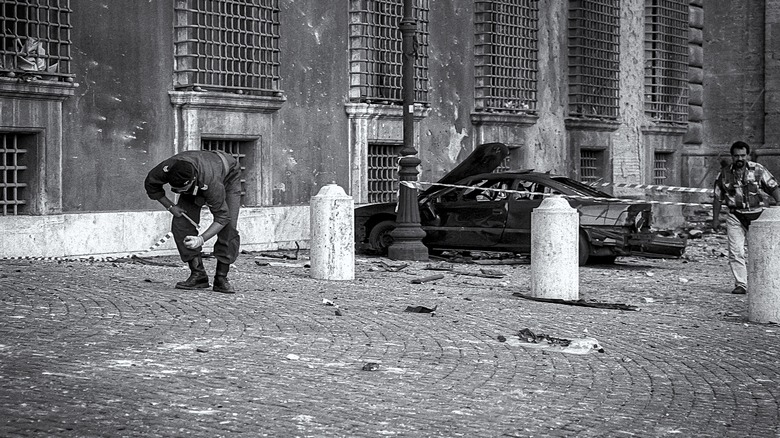 Policemen search around St. John Lateran after 1993 bombing