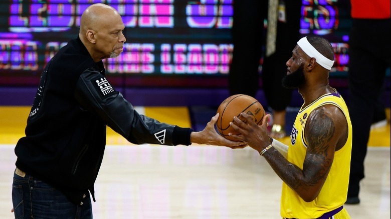 Abdul-Jabbar hands James basketball