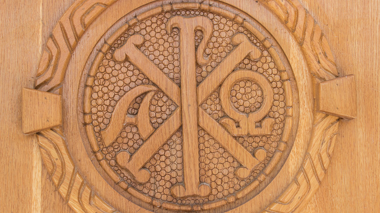 Wooden carving of the chi ro and alpha and omega