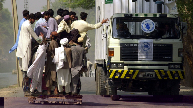 Refugees pass a food aid truck in Afghanistan 