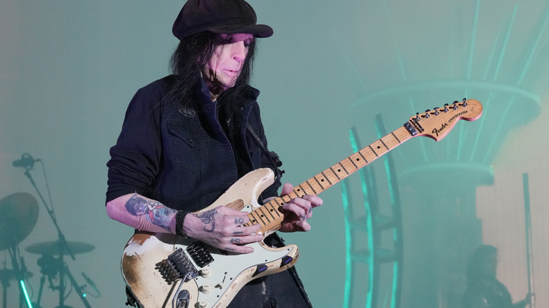 Mick Mars on stage playing guitar