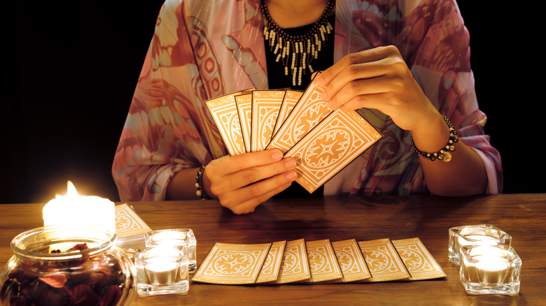 psychic holding tarot cards