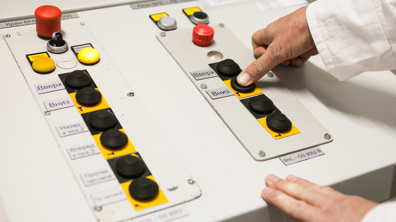 Male hands on control panel